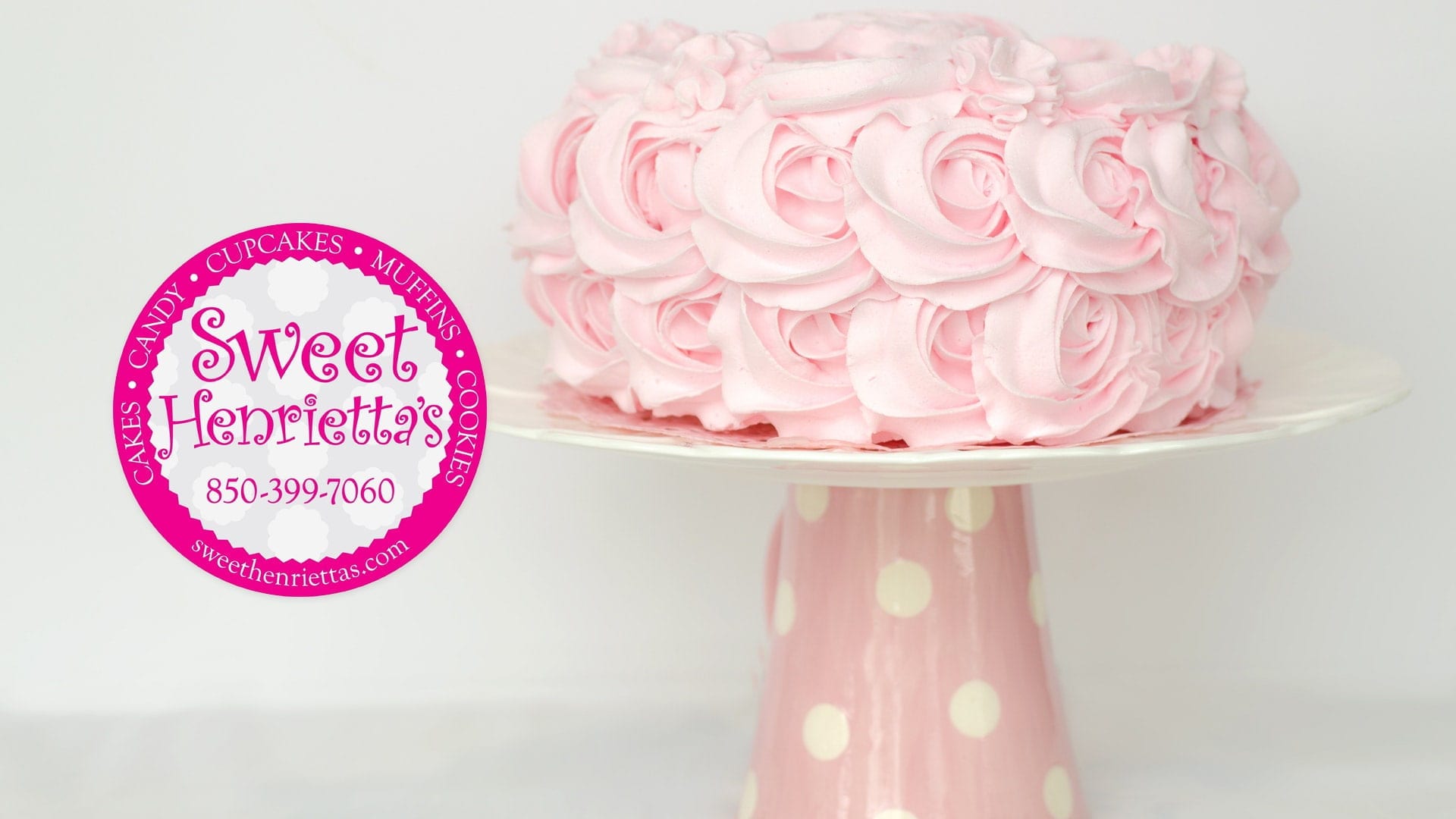 Pink cake with flower design frosting.